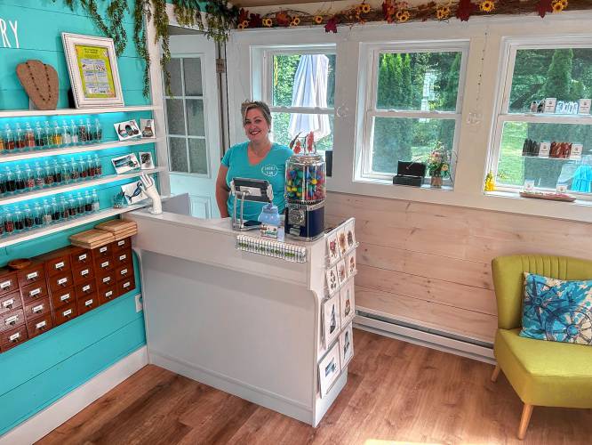 Ashleigh Nelson, owner and creator of Earthly Elan, behind the counter of her business.