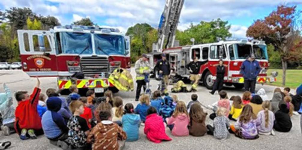 Peterborough Elementary School students visit with members of Peterborough Fire and Rescue.