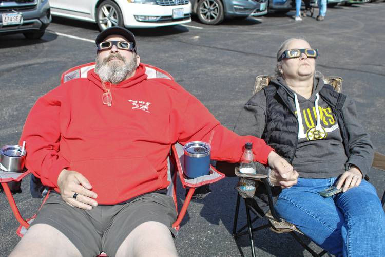 Michael and Charmaine Hartman of Fitchburg found a good spot in the Cathedral of the Pines parking area to view the eclipse.
