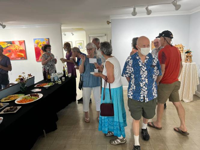 Visitors attend a Jaffrey Civic Center art reception.