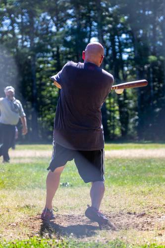 Temple Fire Chief George Clark hits the ball.