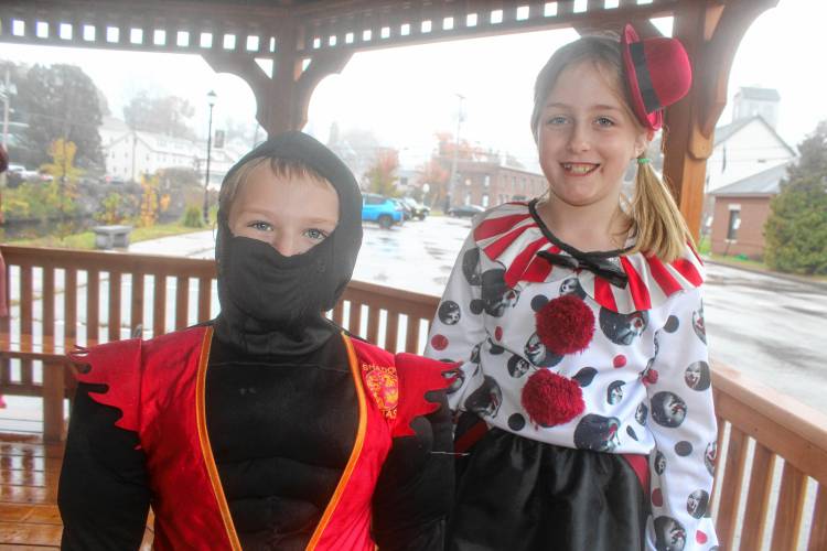 Ninja TJ and clown Bella Guay of Wilton ready to collect candy on Wilton’s Main Street.