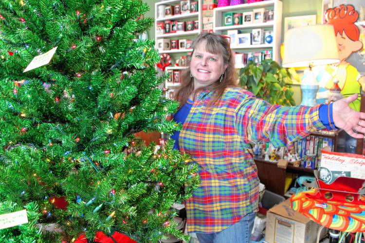 Kari Lindstrom, owner of The Melamine Cup in Jaffrey, dons plaid during her vintage Christmas sale on Plaid Friday.