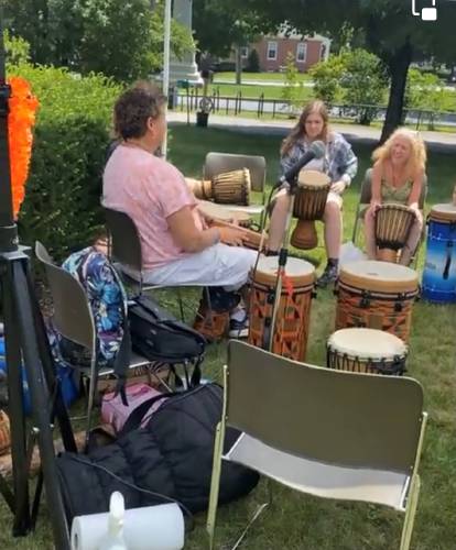 A drumming circle with the village drum at the 2021 Front Lawn Fun program.