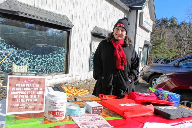 TEAM Jaffrey Executive Director Tara Castiglioni sells reward cards with discounts to local businesses, and urges people to shop local this holiday season, on Plaid Friday.