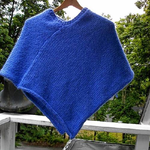 A handknit child’s cotton poncho by Buddie Sweaters. 