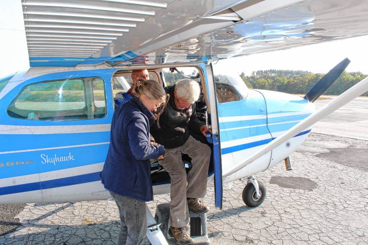 Meg Coleman helps her father Bill from a Cessna Skyhawk after a jaunt around Jaffrey and Rindge.