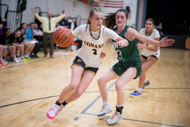 Conant senior captain Bella Hart drives to the rim as Hopkinton’s Shaylee Murdough defends during the Hawks’ 42-34 win over the Orioles in Jaffrey on Monday.