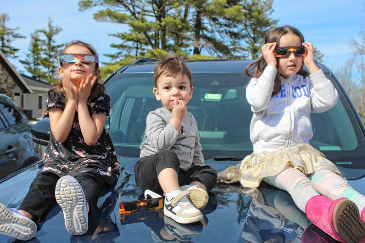 Riya Virostko, Mehdi Virostko and Malani Nunez are ready for eclipse viewing with their eclipse glasses.