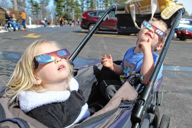 Emilia and Henry Amoling of Sterling, Mass., watch the eclipse reach near-totality.