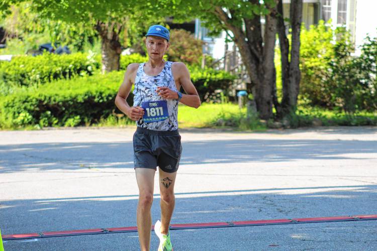 First-place finisher Benjamin Pyhala of Rindge finishes the Le Tour de Common 5K on Saturday.