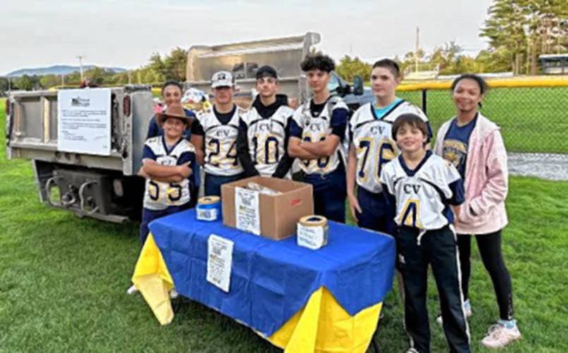 Members of ConVal’s football team help collect donations.