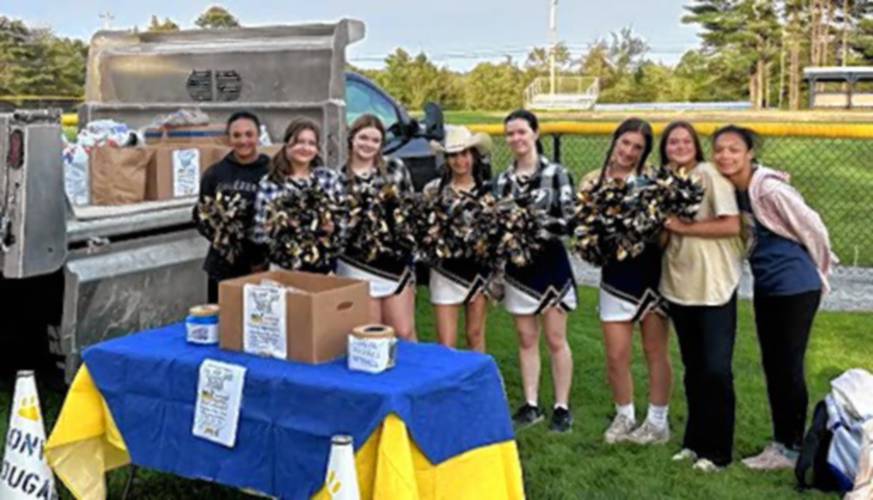 Members of ConVal’s cheerleading squad help collect donations.