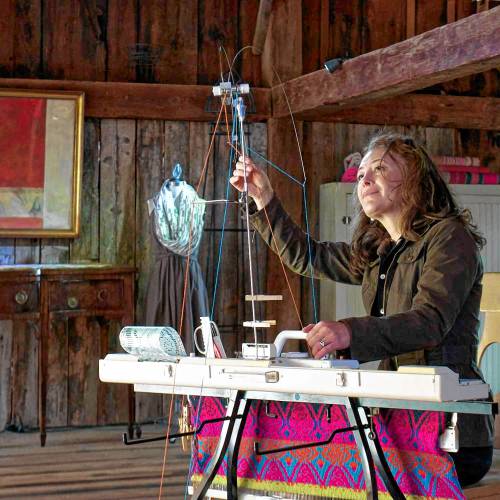 Raisa Lawrence West at her weaving machine. 