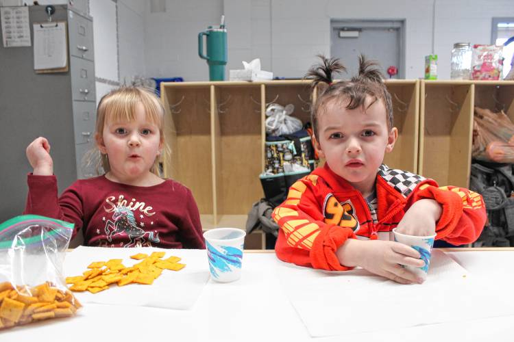Mya Cote and Michael Dibble enjoy snack time at the Little Orioles day care program at Conant Middle High School.