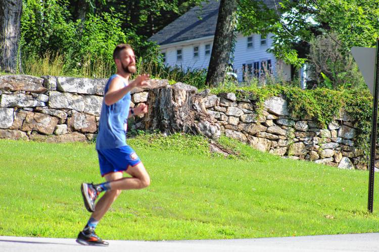 Runners race for the finish during the Rindge Le Tour de Common 5K Saturday.