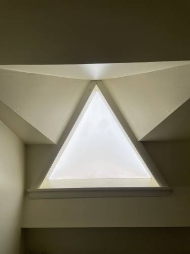 The triangle-shaped skylight in the bathroom. 