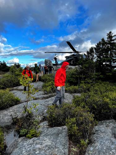 Rescuers and a New Hampshire Army National Guard helicopter at Monadnock State Park.