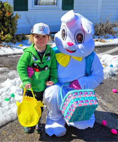 Tristen Kelly meets with the Easter Bunny before hunting for eggs in the snow at the Mason Public Library.