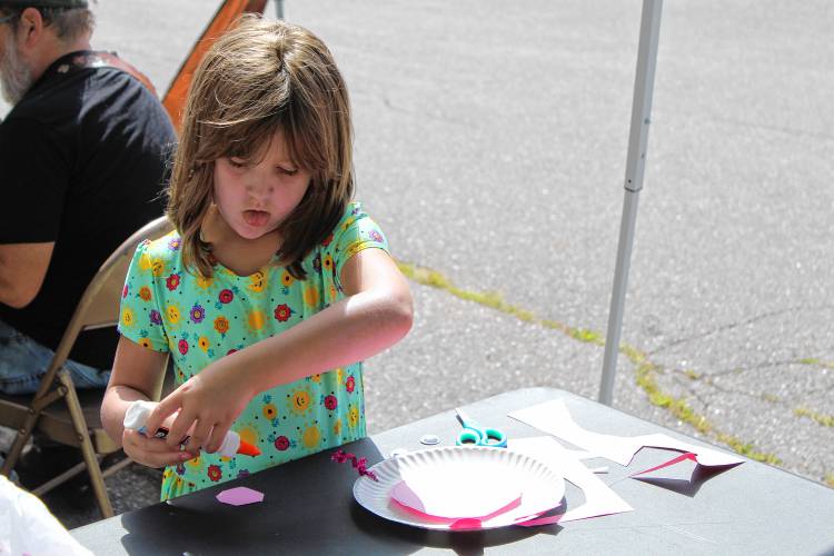 Brenna Beauvais, 6, of Winchendon, makes a paper craft at Greenville Old Home Day.