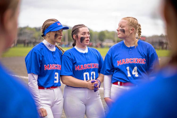 Mascenic's Delaney Traffie, left, Katalina Davis and Ella Pearson talk with the team before Wednesday's NHIAA Division IV softball semifinal game against Woodsville at Plymouth State College.