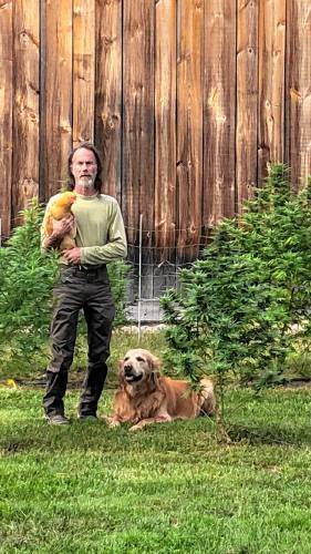 Michael Wisniewski with his dog and chicken with the crops of Barnside Hemp.
