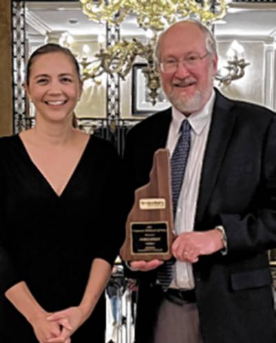 Mark Bodin  president of Savings Bank of Walpole, receives the 2023 Community Banker of the Year from Kristy Merrill, president of New Hampshire Bankers Association.