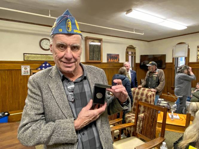 Joseph McLellan of New Ipswich with his father’s boot tag from World War II, which was found in a cave on Guadalcanal.