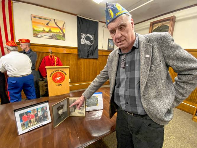 Joseph McLellan of New Ipswich points to a photo of his father, also named Joseph, in uniform, which he said was the only indication in his family’s house that his father was in the mil