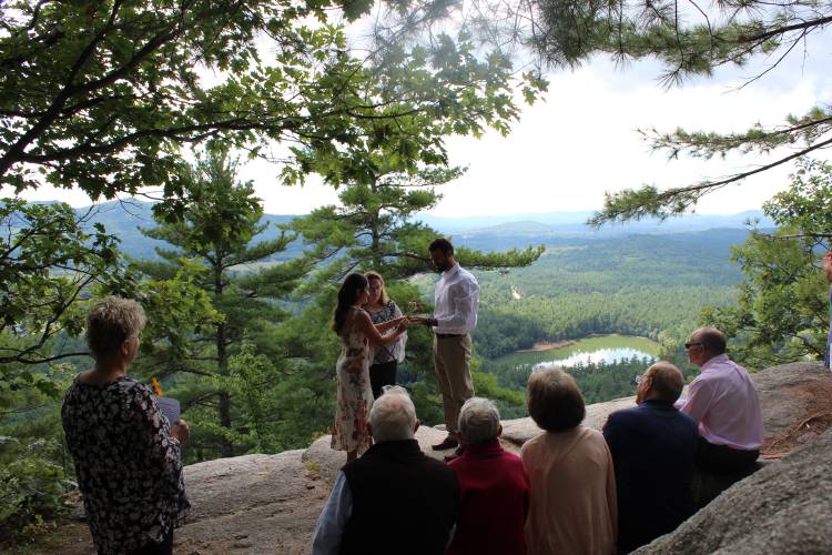 A New Hampshire couple holds a surprise wedding ceremony with their close family in attendance at Cathedral Ledge in Conway, N.H.