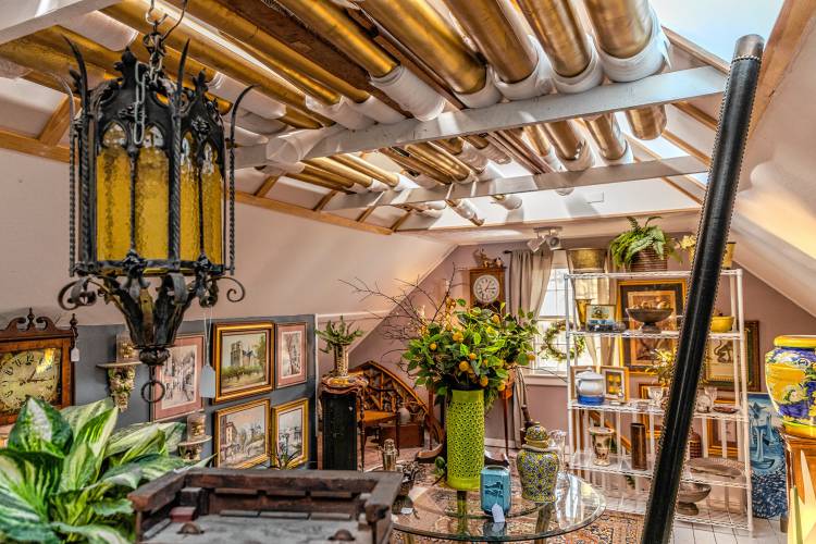The upstairs of Hayfields Antiques, fitted with clocks, art and a roof slatted by organ pipes being restored by co-owner Thomas R. Thomas.