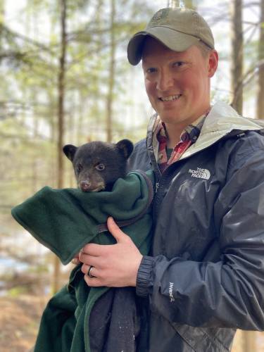 Dan Bailey and a bear cub.