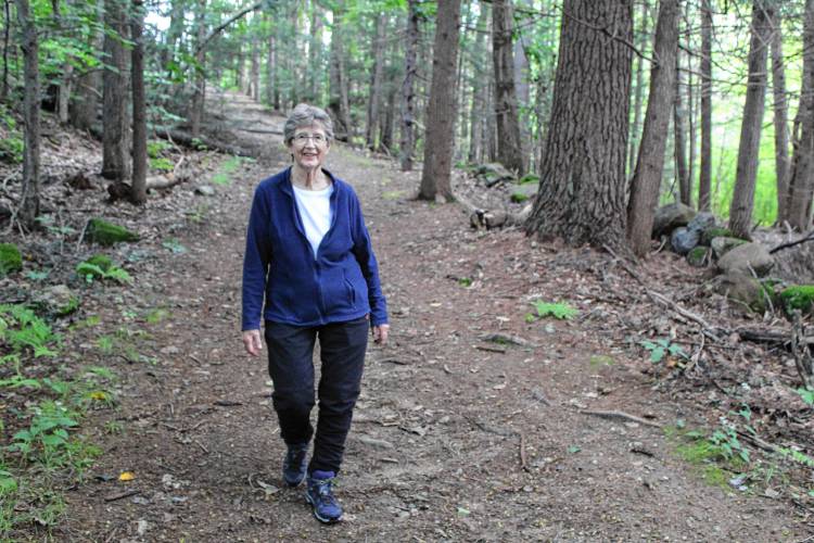 Jaffrey Conservation Commission member Carolyn Garretson walks the trail in Carey Park, which the town is working to put under a conservation easement.