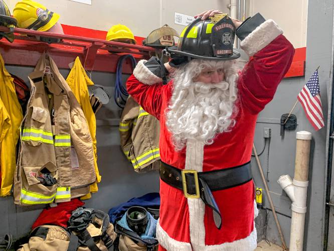 New Ipswich and Greenville firefighter Jim Feldhusen puts on his Firefighter Santa outfit.