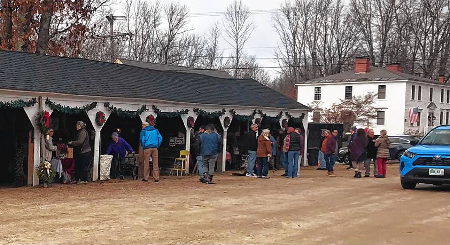 Volunteers from the Francestown Recreation Committee cleaned out and decorated the historic Francestown horse stalls for the German Holiday Market on Saturday. 