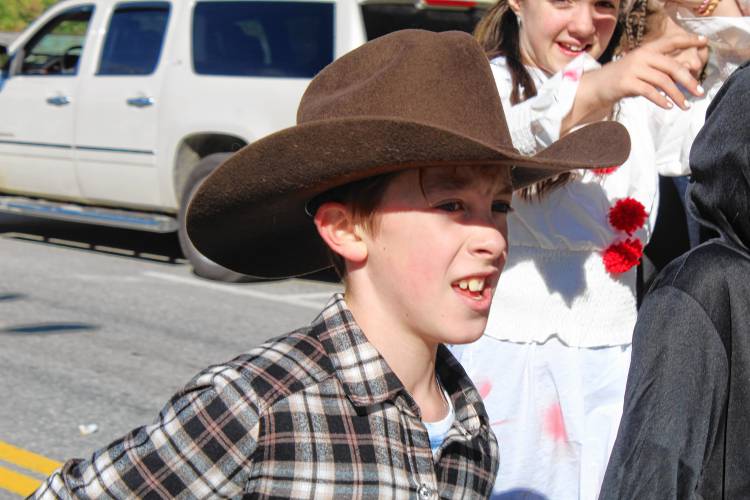 FRES fifth-grader Wyatt MacFadzen, dressed as a cowboy, makes his way down Main Street with his class.