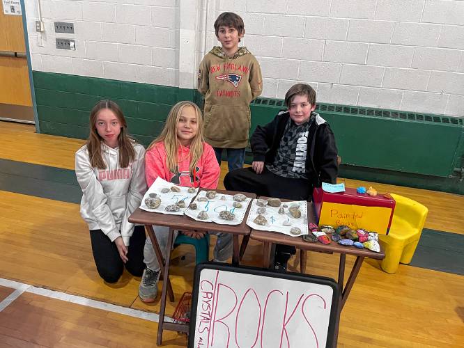 Students from Peterborough’s children’s program, located in the community center, with their display of quartz, homegrown crystals and hand-painted rocks. 