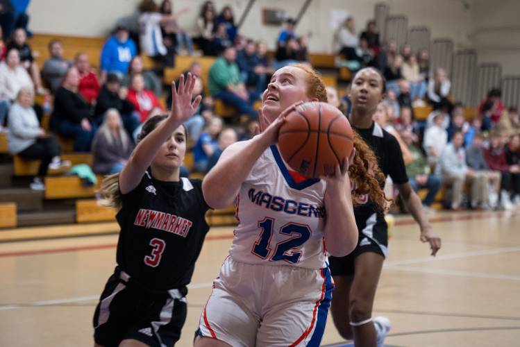 Mascenic's Lorelai Shippee goes for a shot against Newmarket during the Vikings' season opener in New Ipswich on Friday, Dec. 1.