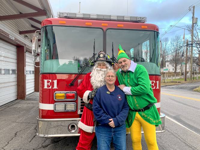 New Ipswich and Greenville firefighter Jim Feldhusen as Firefighter Santa with Buddy the Elf, played by firefighter Charlie Jackman, and their driver, Laura Pelletier.