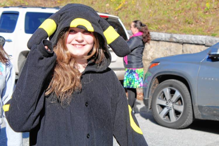 Isabel McKown, dressed as the Pokemon Umbreon, waves as she marches with her fifth-grade class.