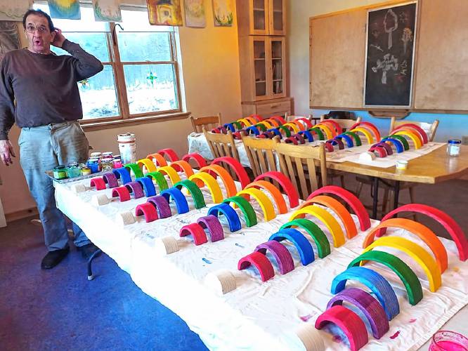 Donat Bay with naturally stained wooden rainbow play sets made at Plowshare.