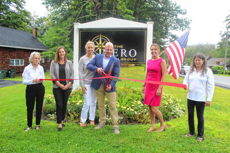 Rindge Chamber of Commerce member Sue Tussing, Nero Wealth Group wealth administrator Jennette Aho, Kara Nero, Nero Wealth Group Managing Director Jason Nero, wealth administrator Amy Holombo, and Chamber of Commerce member Lois Eddy cut the ribbon for the Nero Wealth Group offices on 2 Mountain Road in Rindge.