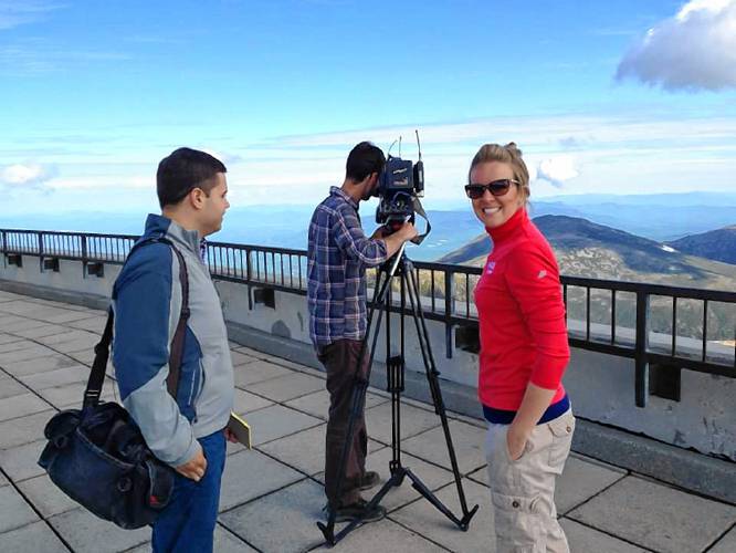 Cyrena Arnold on the summit of Mount Washington with a Vermont television station.