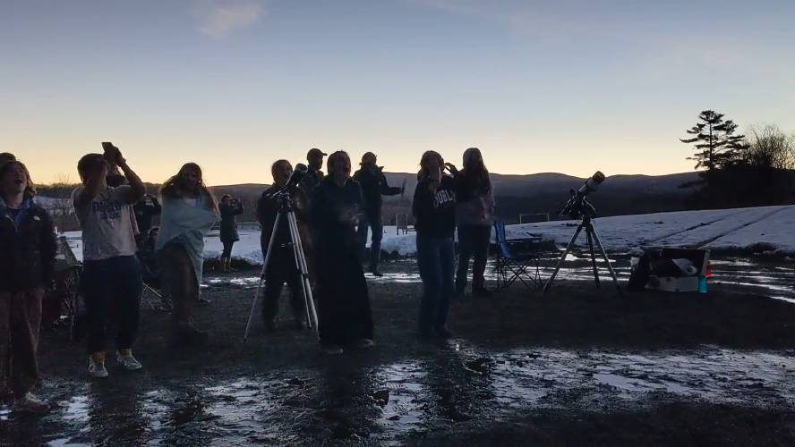 Students and teachers from Dublin School and Vermont Academy experience the first moments of totality at 3:27 p.m.
