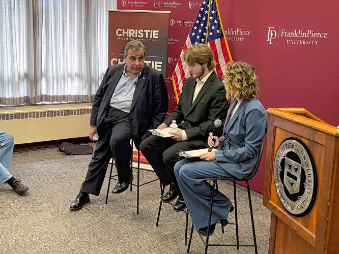Former New Jersey Gov. Chris Christie answers questions from Franklin Pierce University students Coleby Vasoll and Jenna Parent.